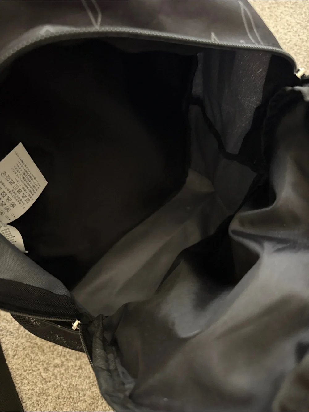 Nike Black Backpack with White Drip Logo.